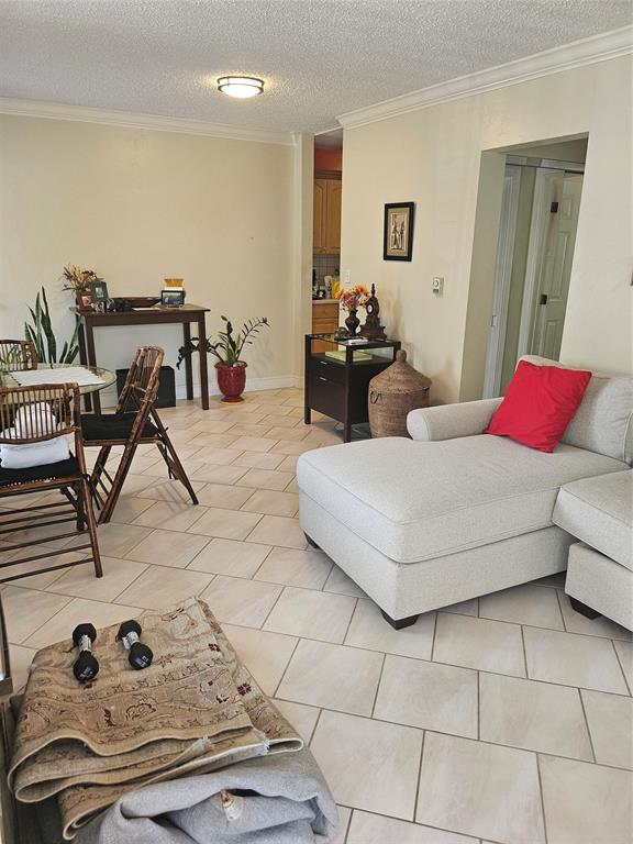 1045 Southeast 15th Street, Unit 13C Fort Lauderdale, FL 33316 - Photo 7 of 20 a living room with furniture and a table