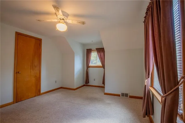 a bathroom with a toilet and shower