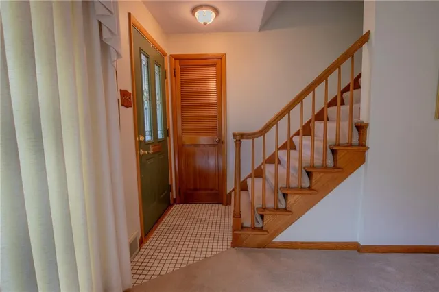 a view of an empty room with fireplace and a window