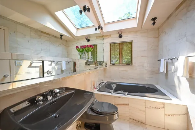 a bathroom with a sink a toilet and bathtub