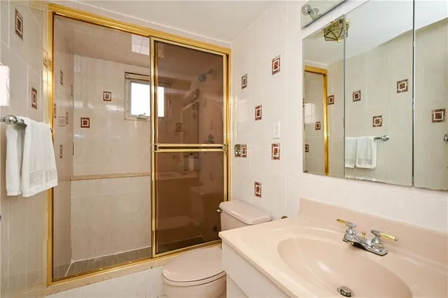 a bathroom with a sink toilet and shower