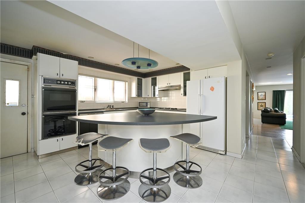 29 Kansas Place Brooklyn, NY 11234 - Photo 20 of 24 a kitchen with stainless steel appliances granite countertop a sink and a refrigerator