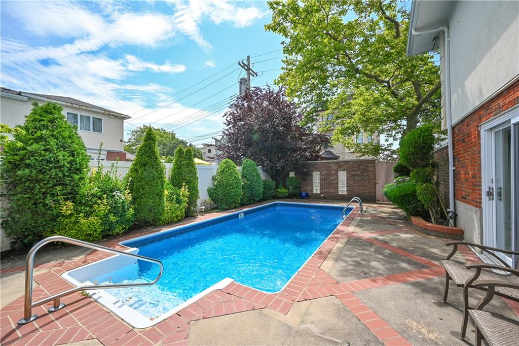 29 Kansas Place Brooklyn, NY 11234 - Photo 22 of 24 a view of a backyard with table and chairs with plants and wooden fence