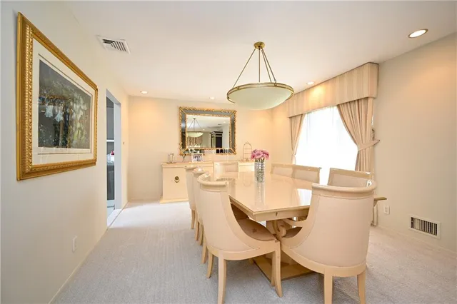 a view of a dining room with furniture and a window