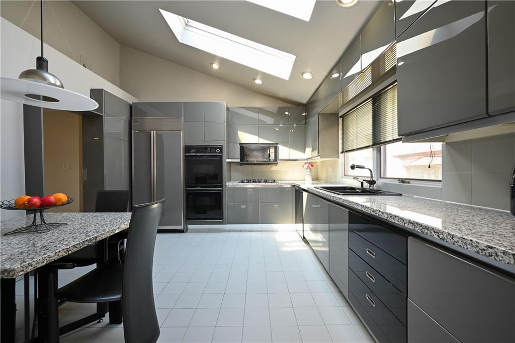 29 Kansas Place Brooklyn, NY 11234 - Photo 8 of 24 a large kitchen with granite countertop lots of counter top space and stainless steel appliances