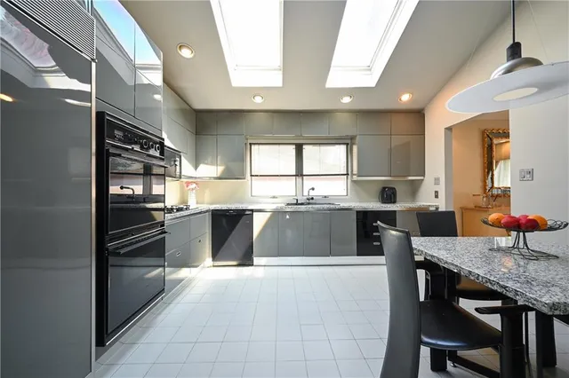 a large kitchen with granite countertop lots of counter space and breakfast area