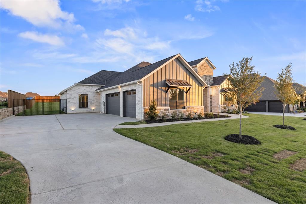 108 Bel Grand Road Haslet, TX 76052 - Photo 2 of 40 View of front of home with board and batten siding, stone siding, concrete driveway, and an attached garage