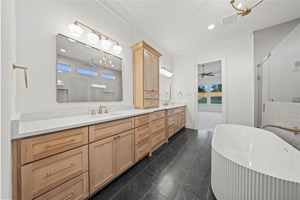 108 Bel Grand Road Haslet, TX 76052 - Photo 28 of 40 Full bath featuring a stall shower, double vanity, a freestanding bath, recessed lighting, and crown molding