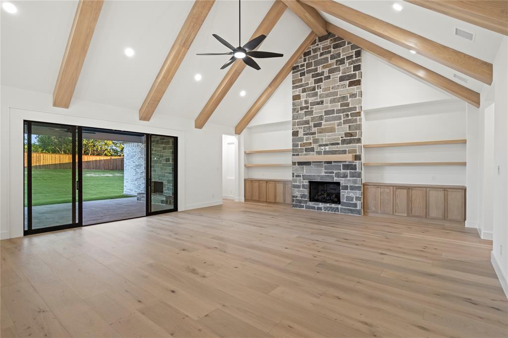 108 Bel Grand Road Haslet, TX 76052 - Photo 32 of 40 Unfurnished living room featuring a fireplace, recessed lighting, ceiling fan, light wood-type flooring, and lofted ceiling