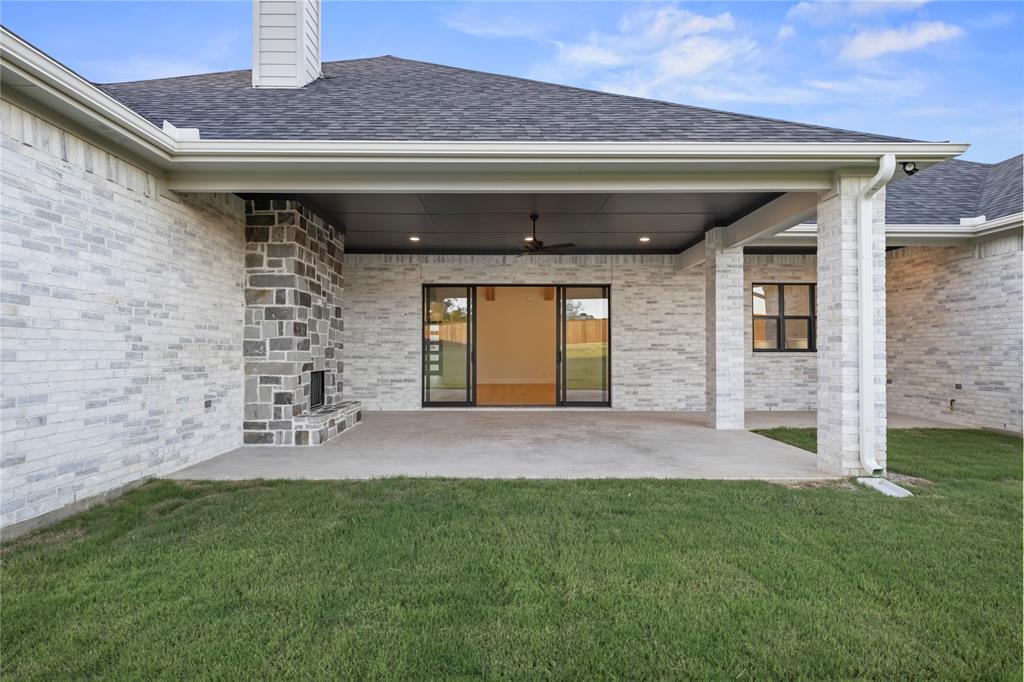 108 Bel Grand Road Haslet, TX 76052 - Photo 36 of 40 Rear view of house with a shingled roof, a patio area, and brick siding