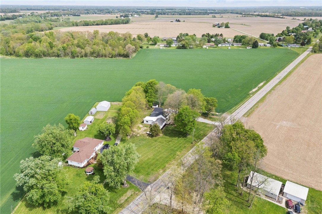 2950 Fairfield Pike Springfield, OH 45502 - Photo 42 of 48 This elevated view showcases a serene rural landscape with a collection of structures nestled amidst expansive green fields.