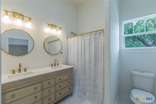 a bathroom with 2 sink and a mirror