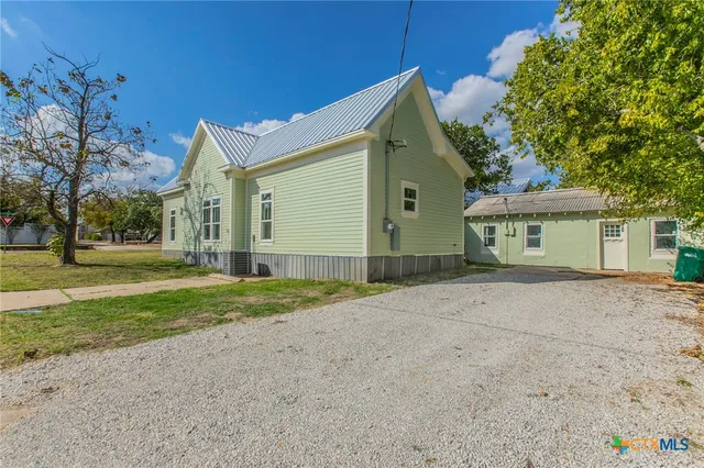 a view of a house with a yard and garage