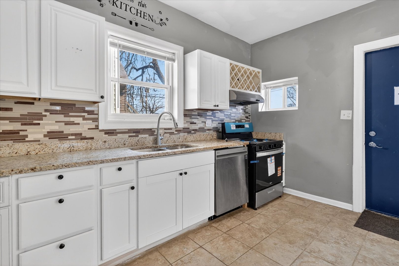 1 East 114th Street Chicago, IL 60628 - Photo 11 of 33 a kitchen with granite countertop white cabinets and white appliances