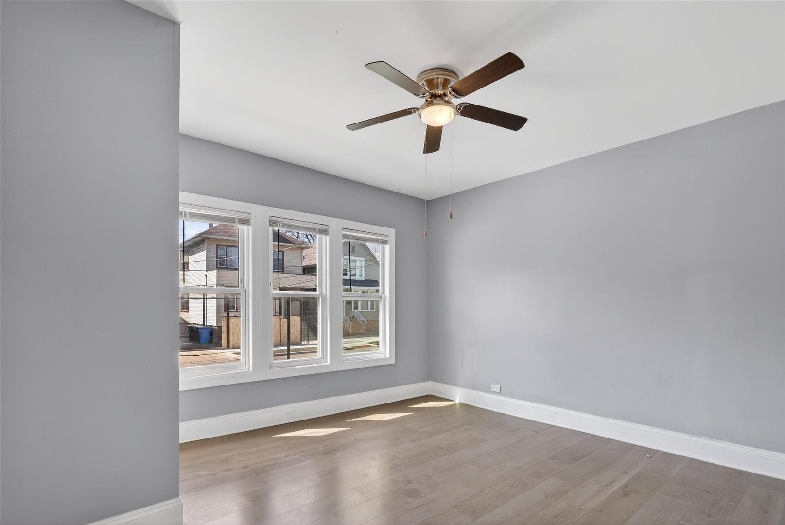 1 East 114th Street Chicago, IL 60628 - Photo 14 of 33 an empty room with window and ceiling fan