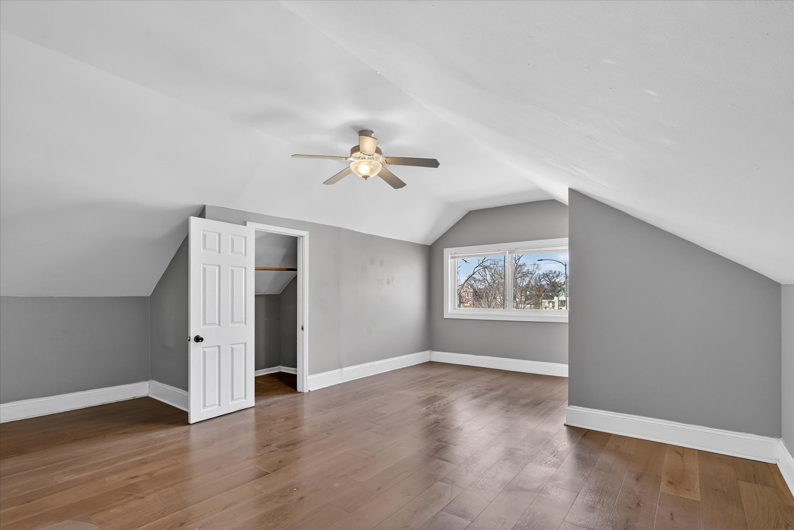 1 East 114th Street Chicago, IL 60628 - Photo 15 of 33 an empty room with wooden floor and ceiling fan