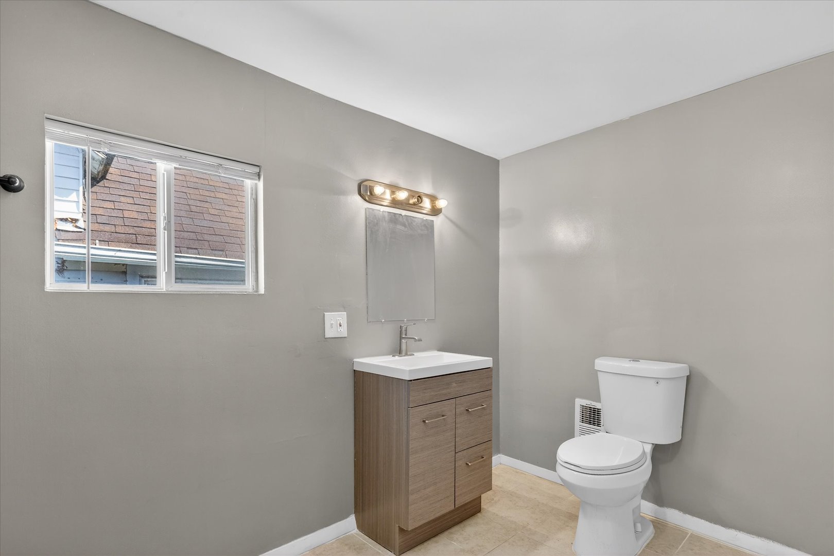 1 East 114th Street Chicago, IL 60628 - Photo 19 of 33 a bathroom with a sink toilet and a window