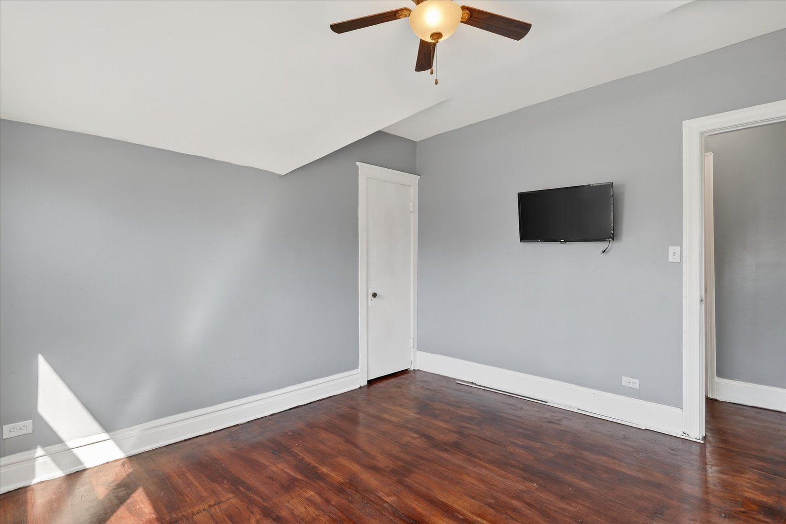 1 East 114th Street Chicago, IL 60628 - Photo 20 of 33 an empty room with wooden floor and chandelier fan