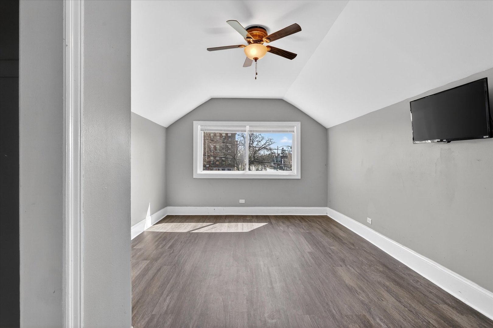 1 East 114th Street Chicago, IL 60628 - Photo 22 of 33 an empty room with wooden floor chandelier fan and windows