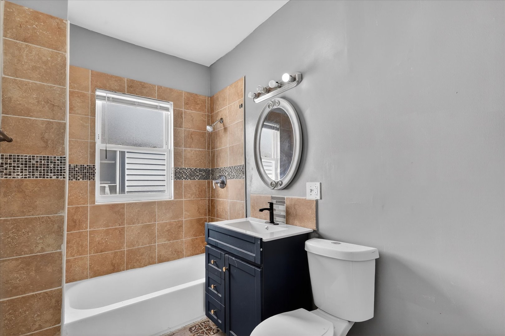 1 East 114th Street Chicago, IL 60628 - Photo 25 of 33 a bathroom with a toilet sink vanity tub and mirror