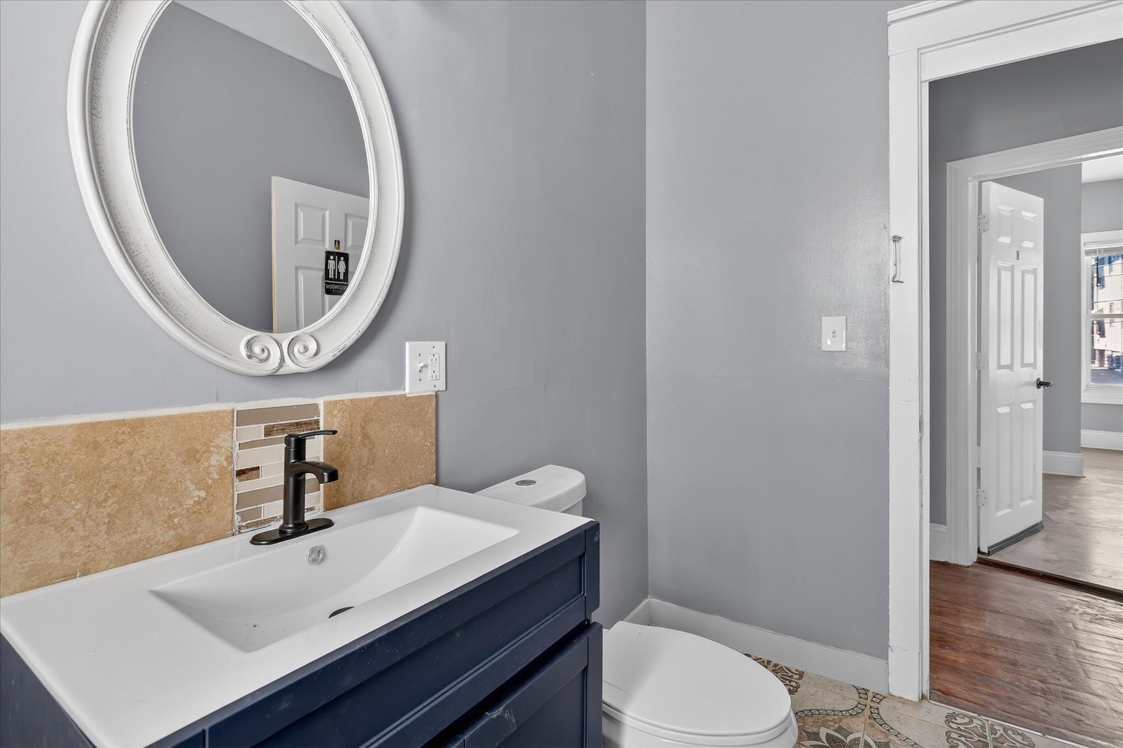 1 East 114th Street Chicago, IL 60628 - Photo 26 of 33 a bathroom with a sink and a mirror