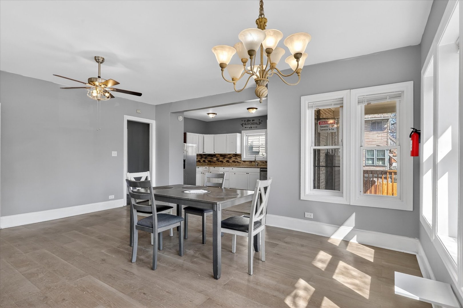 1 East 114th Street Chicago, IL 60628 - Photo 9 of 33 a view of a dining room with furniture a chandelier and wooden floor