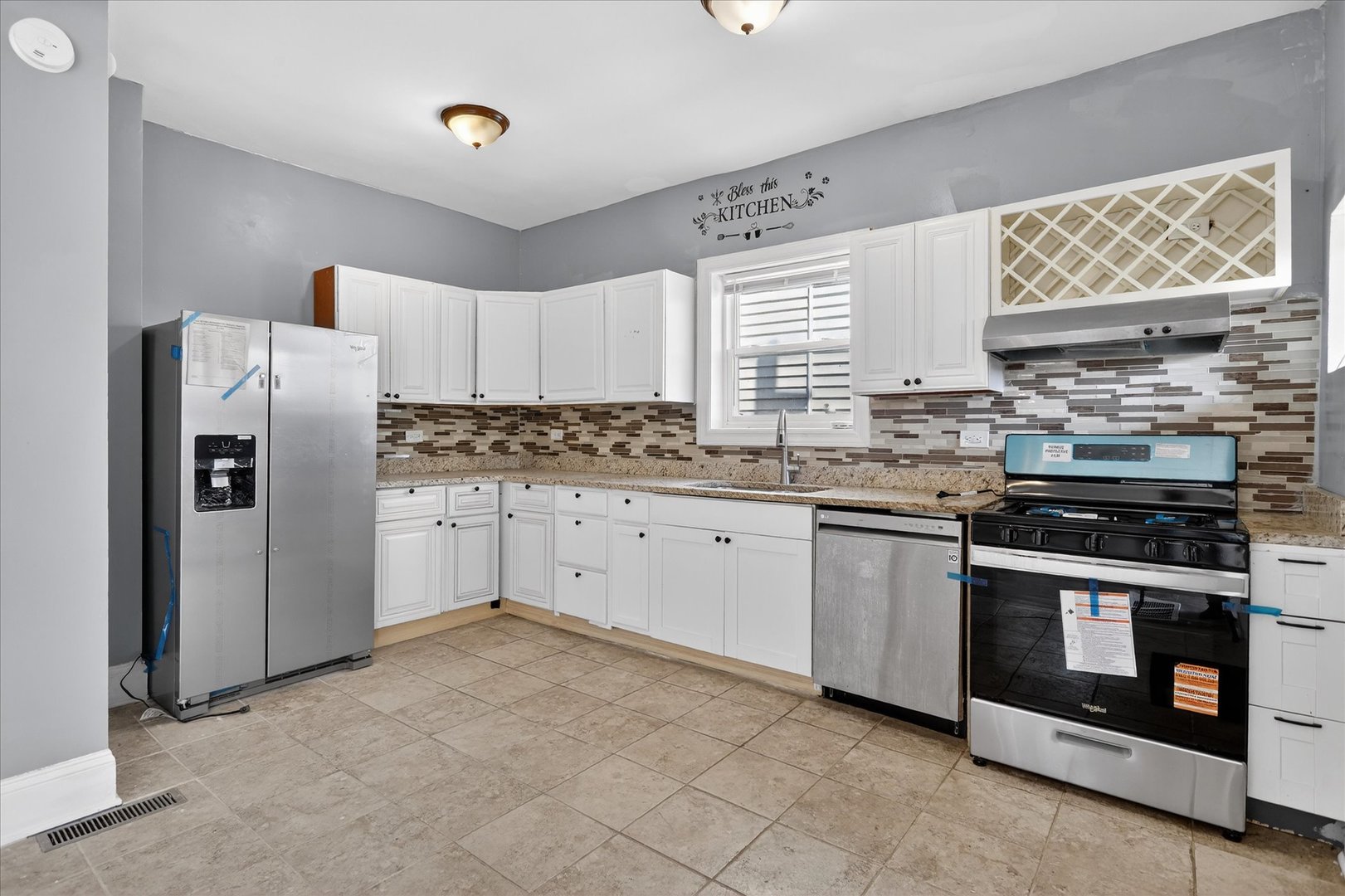 1 East 114th Street Chicago, IL 60628 - Photo 10 of 33 a kitchen with stainless steel appliances granite countertop a stove a refrigerator and a sink