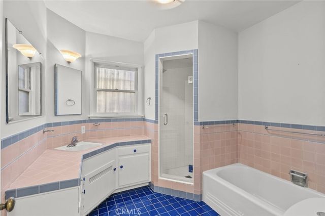 a bathroom with a sink a mirror and a bathtub