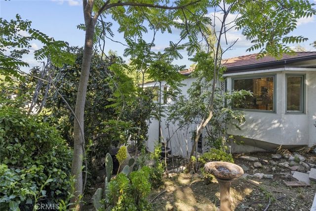 a view of a house with a tree