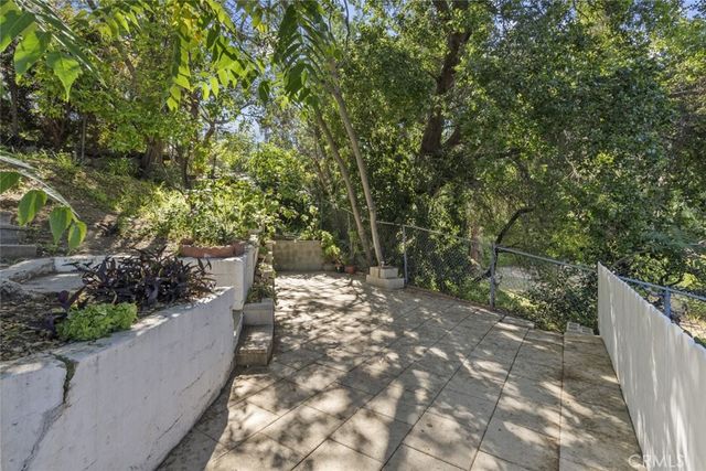 a backyard of a house with a yard and fountain