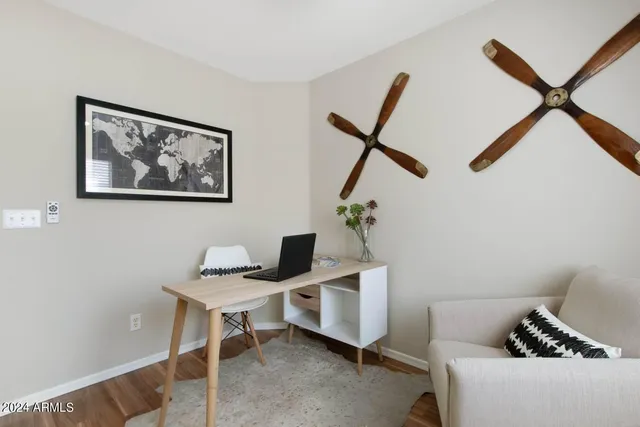 a bedroom with a bed and a potted plant