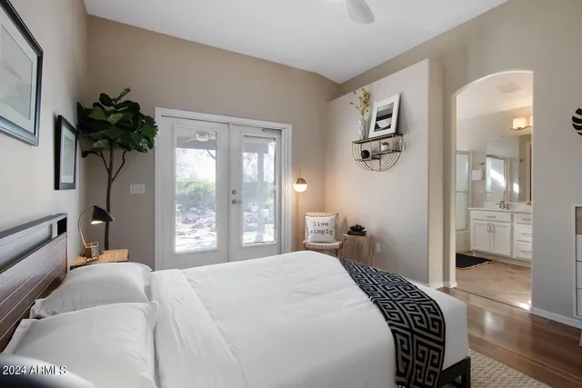 a bedroom with a large bed and a window