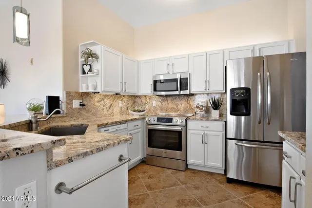 a living room with kitchen island furniture and a chandelier