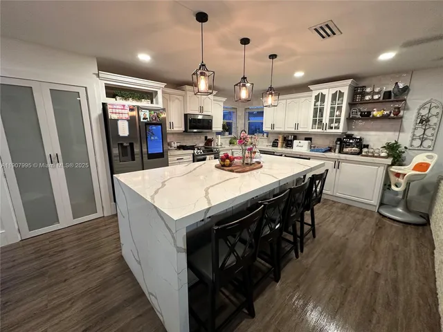 a large kitchen with a table and chairs
