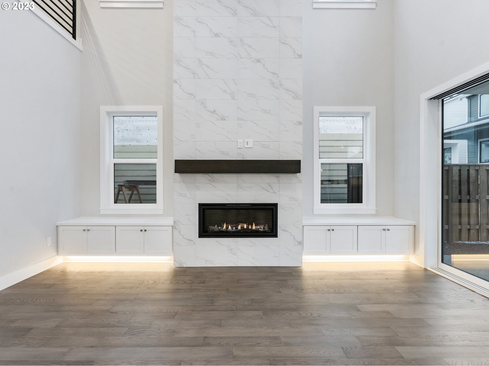 16084 Northwest Ridgeline Street, Unit L 72 Portland, OR 97229 - Photo 11 of 25 a living room with stainless steel appliances granite countertop a fireplace and a hard wood floor