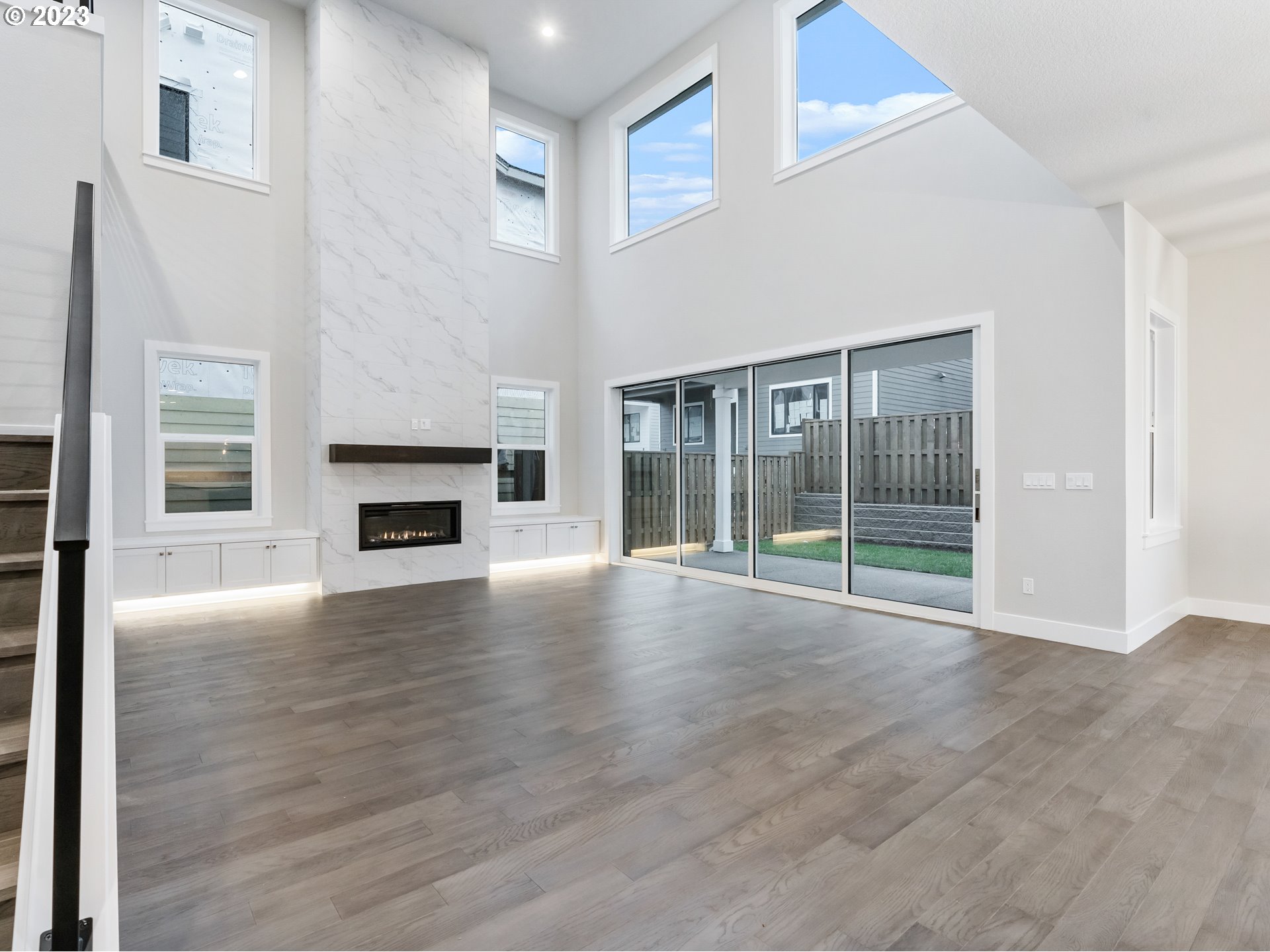 16084 Northwest Ridgeline Street, Unit L 72 Portland, OR 97229 - Photo 12 of 25 a view of empty room with wooden floor and fireplace