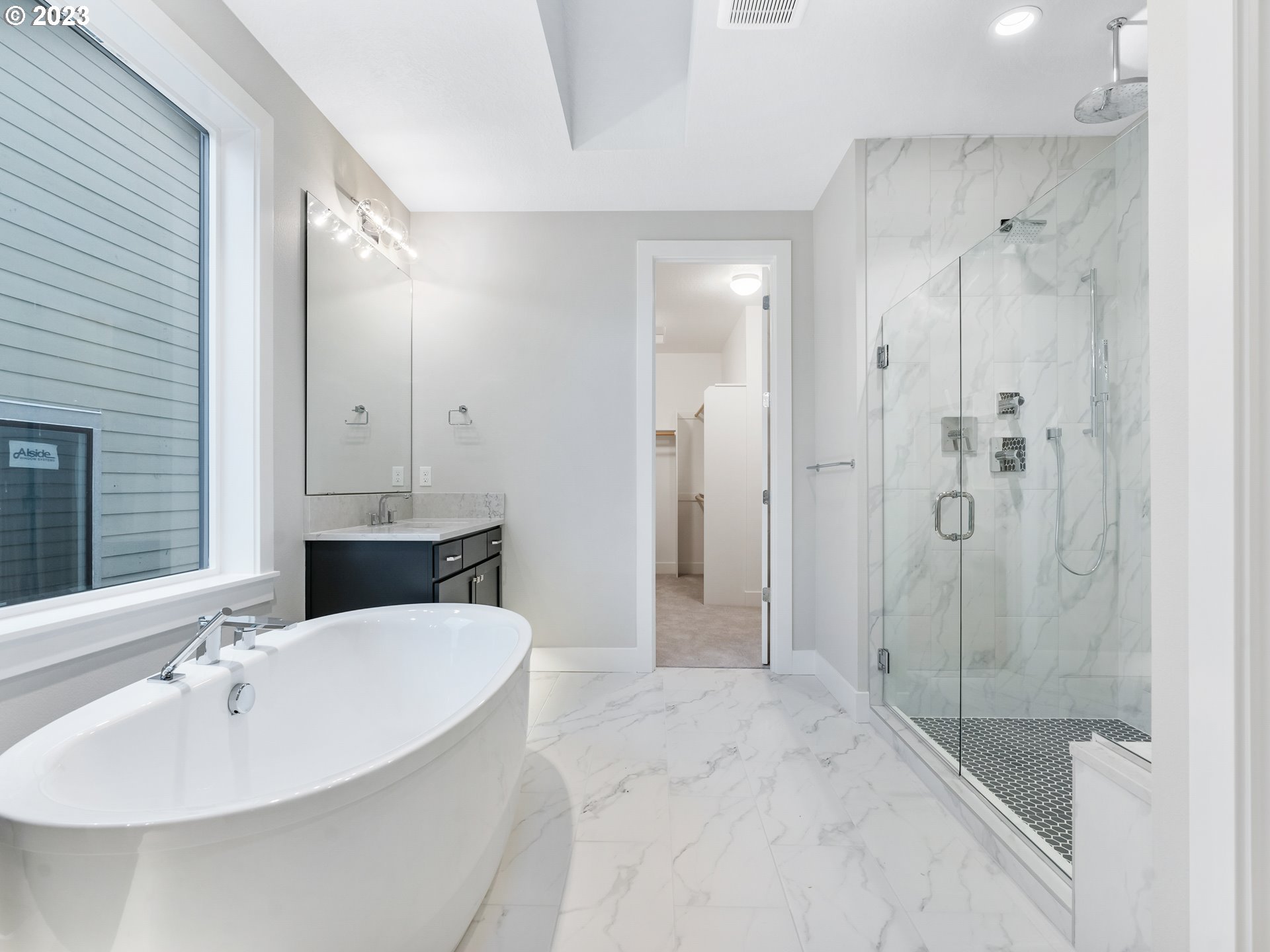 16084 Northwest Ridgeline Street, Unit L 72 Portland, OR 97229 - Photo 17 of 25 a bathroom with a bathtub shower sink and mirror