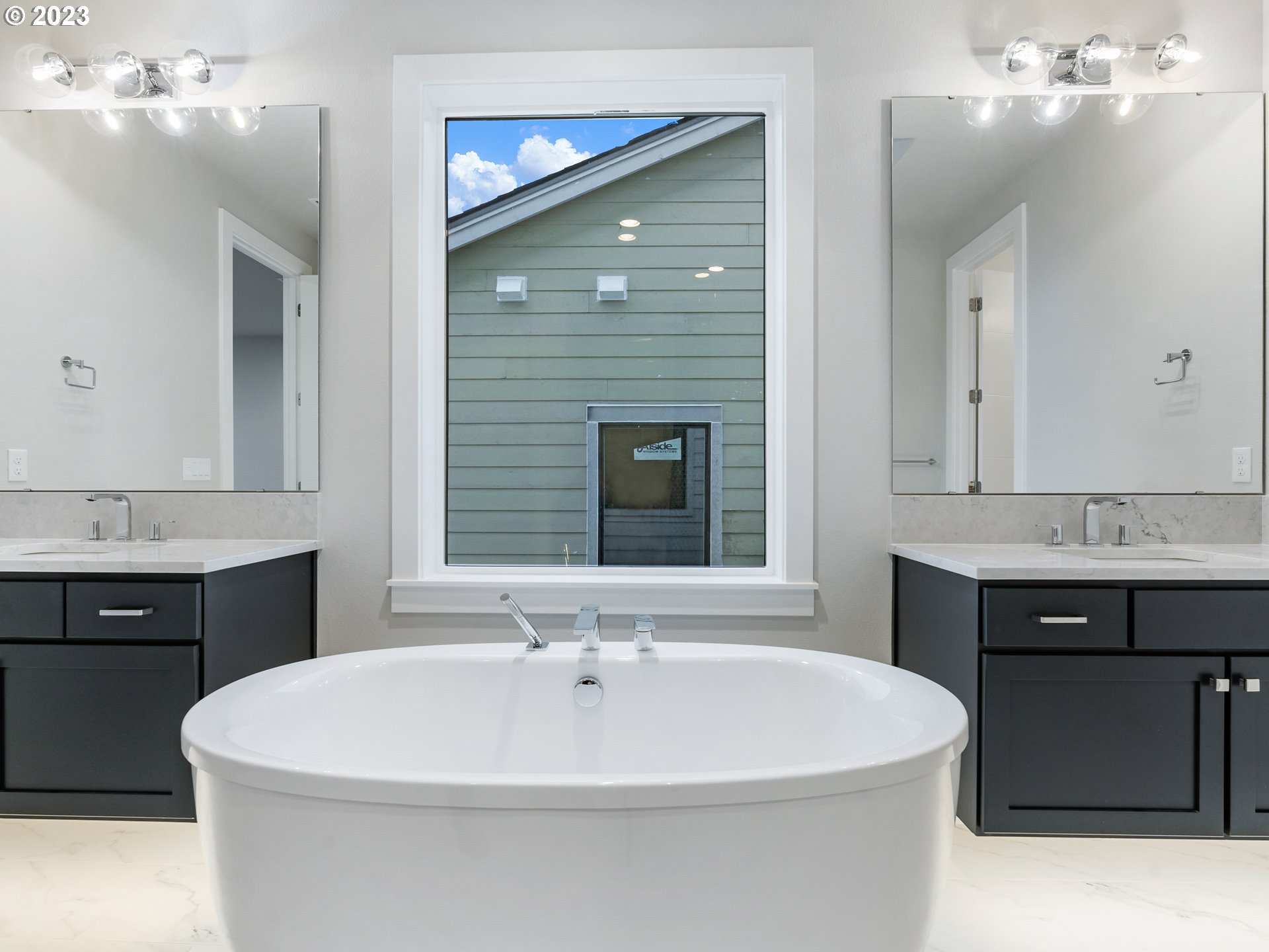 16084 Northwest Ridgeline Street, Unit L 72 Portland, OR 97229 - Photo 18 of 25 a white bath tub sitting in a bathroom and sink