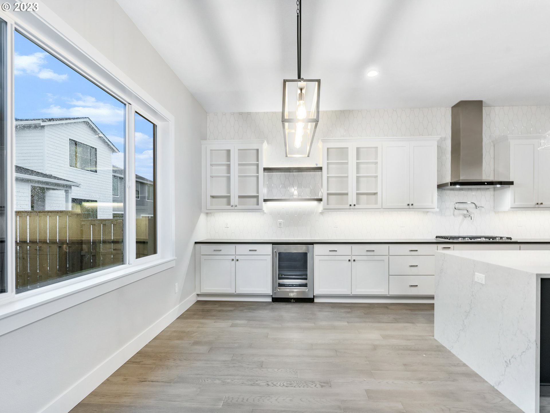 16084 Northwest Ridgeline Street, Unit L 72 Portland, OR 97229 - Photo 5 of 25 a kitchen with granite countertop a sink cabinets stainless steel appliances and a window