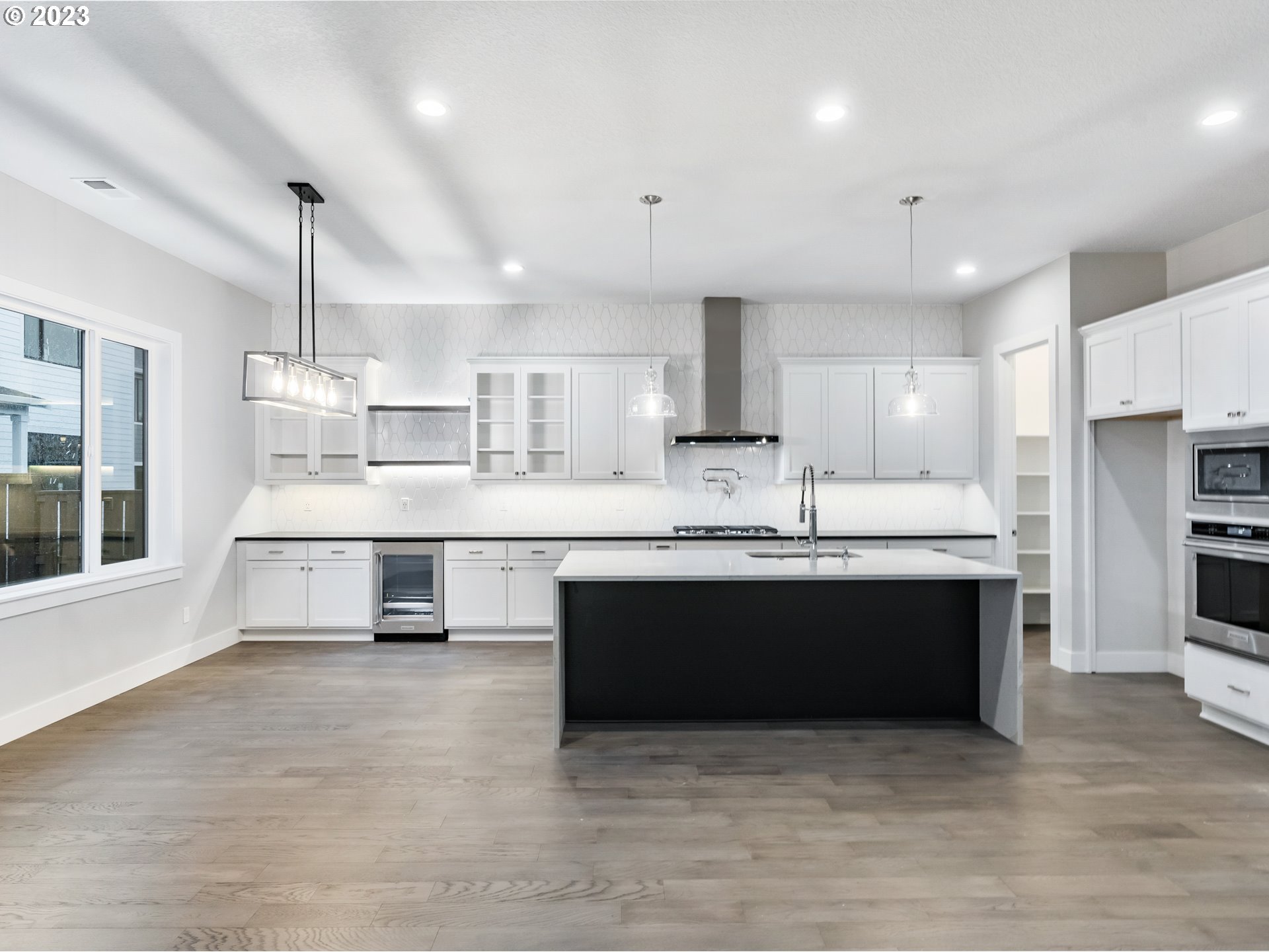16084 Northwest Ridgeline Street, Unit L 72 Portland, OR 97229 - Photo 6 of 25 a large kitchen with stainless steel appliances granite countertop a stove a sink and a refrigerator