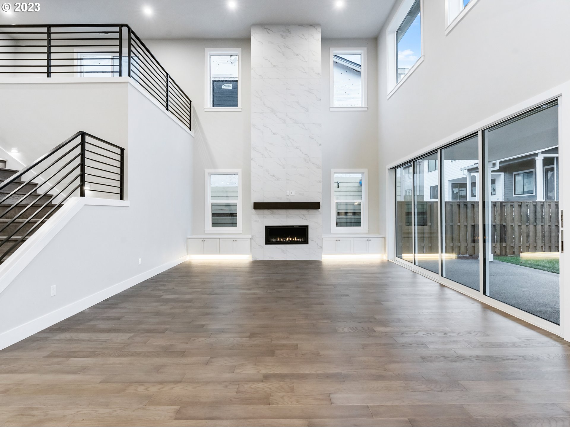 16084 Northwest Ridgeline Street, Unit L 72 Portland, OR 97229 - Photo 10 of 25 a view of a livingroom with wooden floor and a fireplace