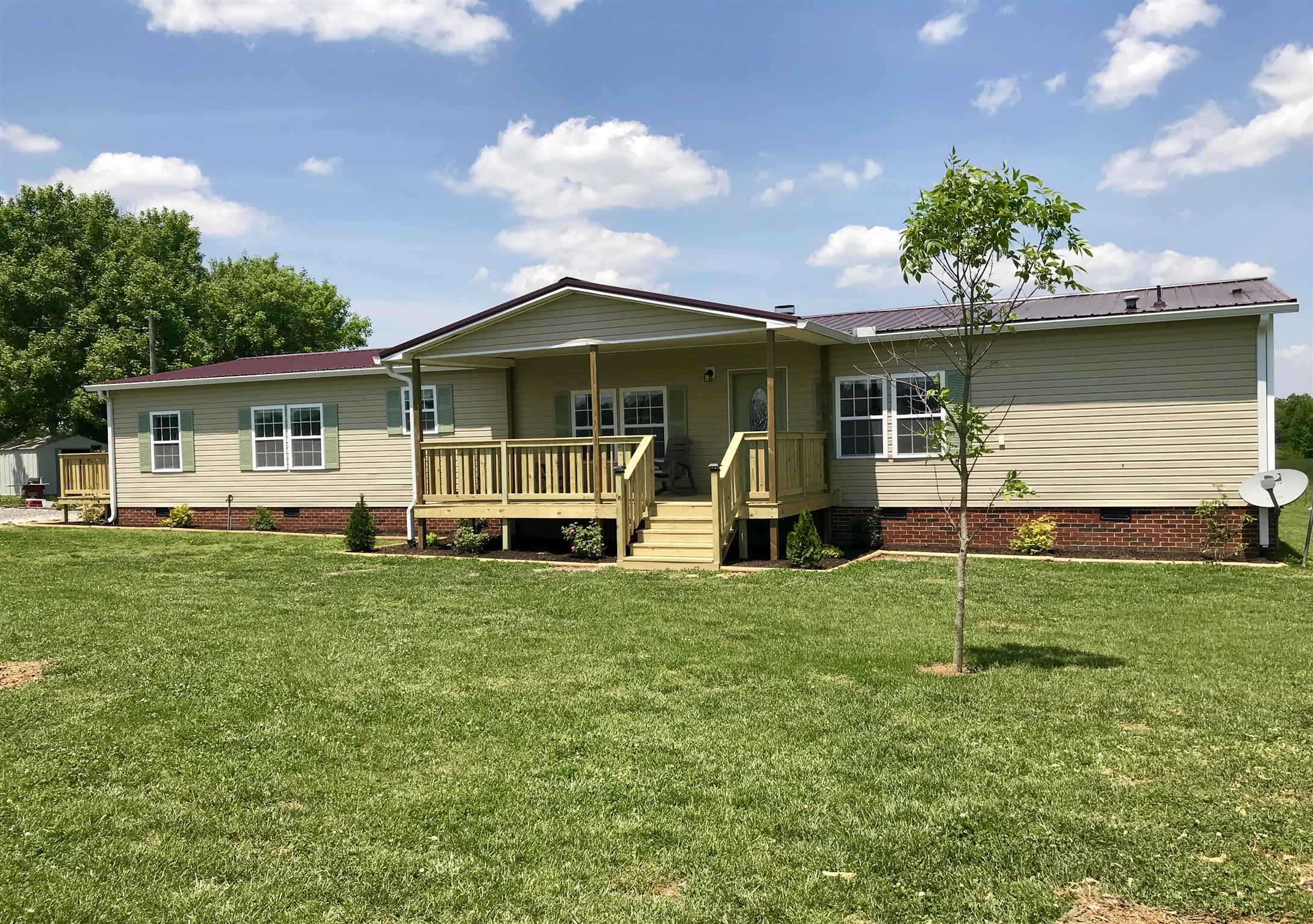 614 Ferrells Loop Road Beechgrove, TN 37018 - Photo 1 of 28 a view of a house with a yard and a garden