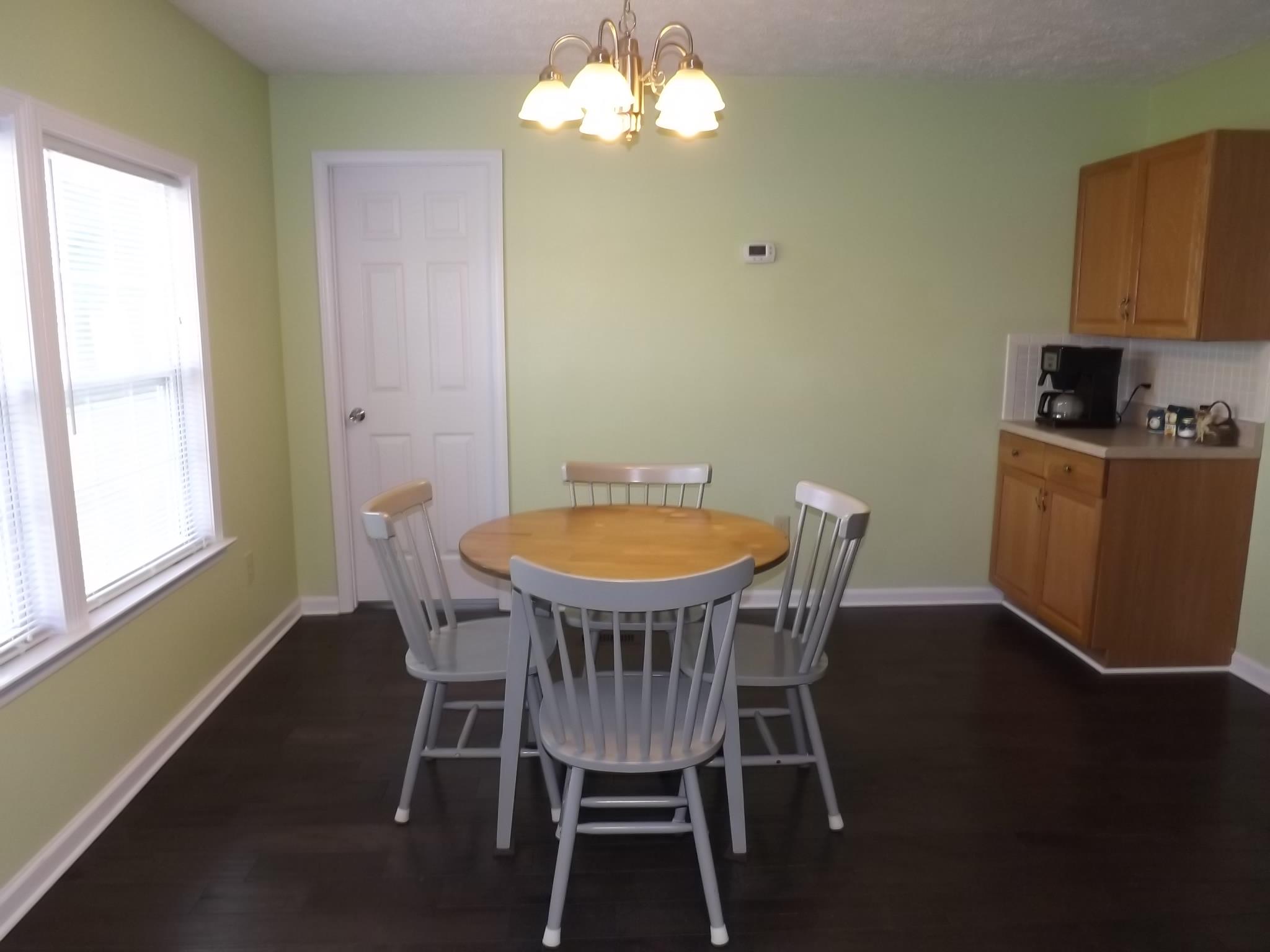 614 Ferrells Loop Road Beechgrove, TN 37018 - Photo 11 of 28 a view of a dining room with furniture window and wooden floor