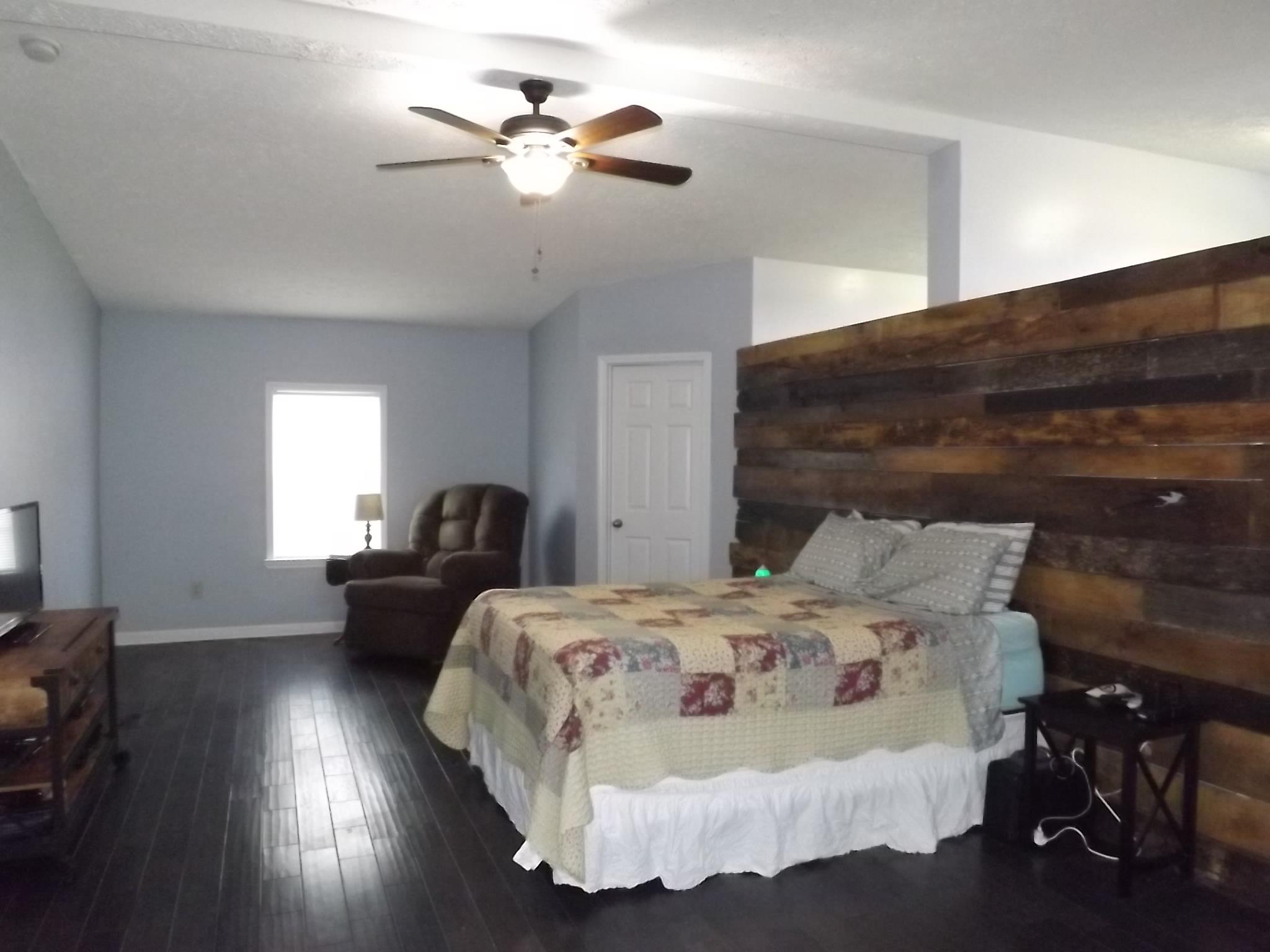 614 Ferrells Loop Road Beechgrove, TN 37018 - Photo 13 of 28 a bedroom with a bed and wooden floor
