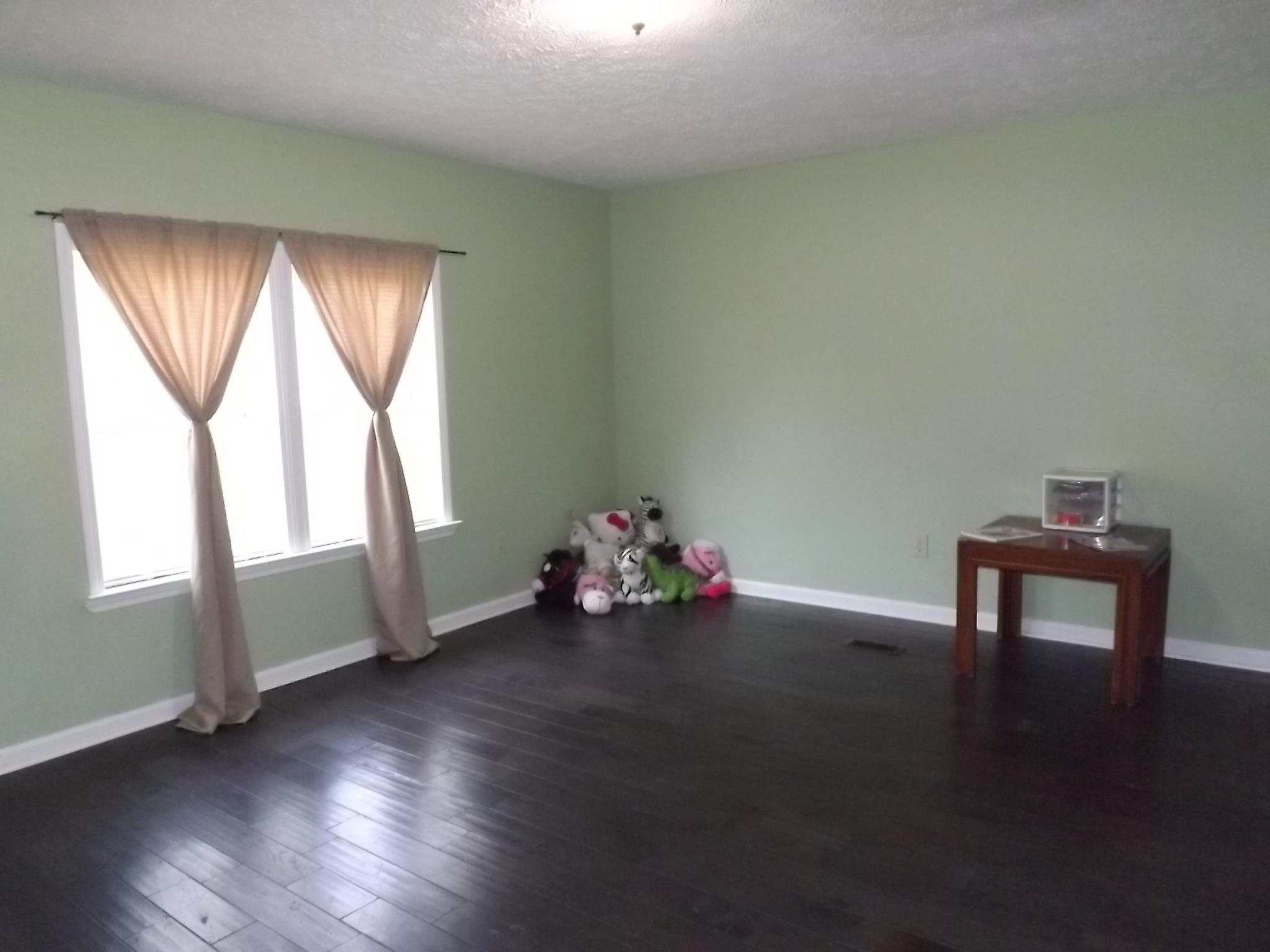 614 Ferrells Loop Road Beechgrove, TN 37018 - Photo 21 of 28 an empty room with wooden floor and windows