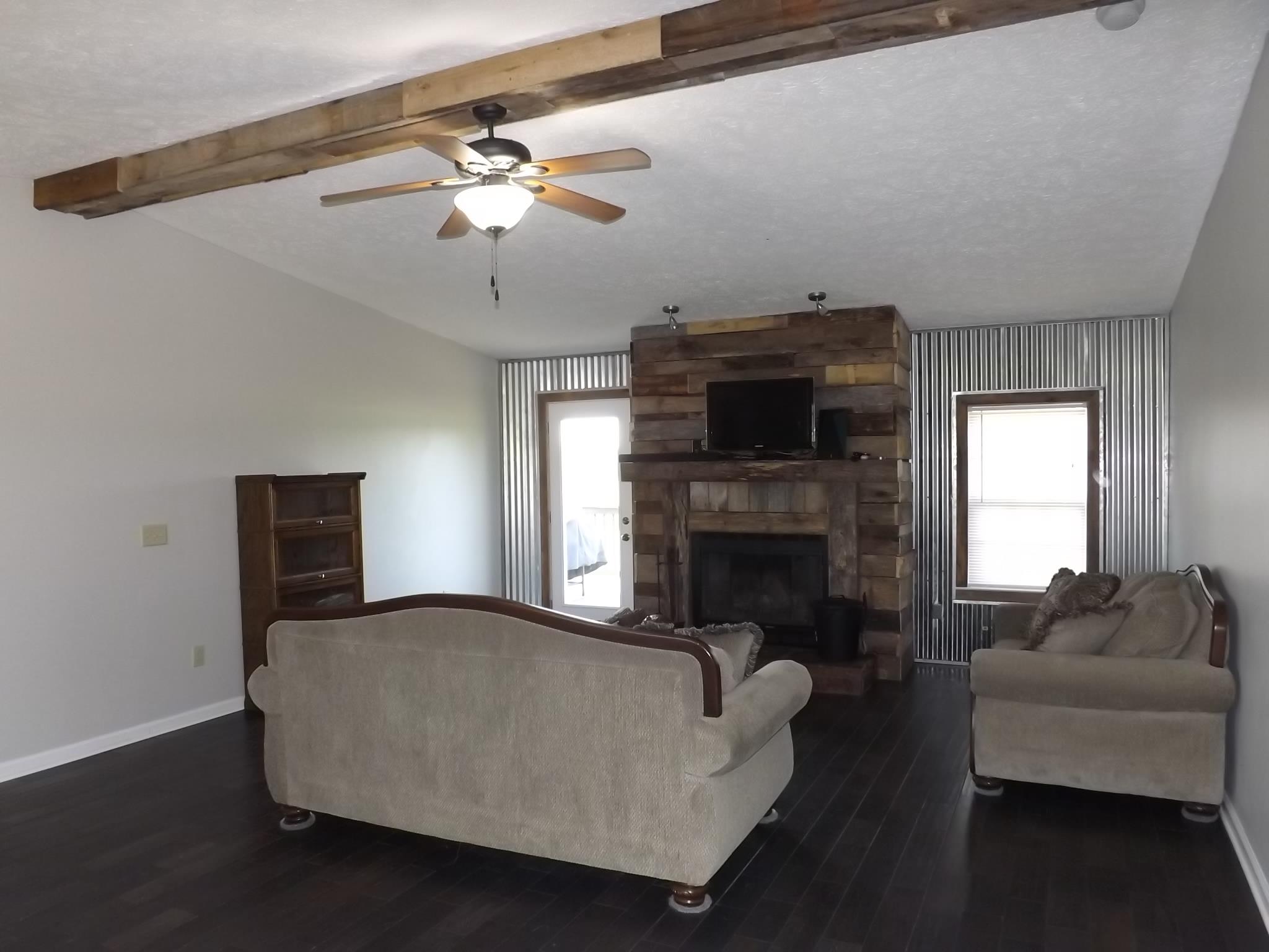 614 Ferrells Loop Road Beechgrove, TN 37018 - Photo 4 of 28 a living room with furniture and a fireplace