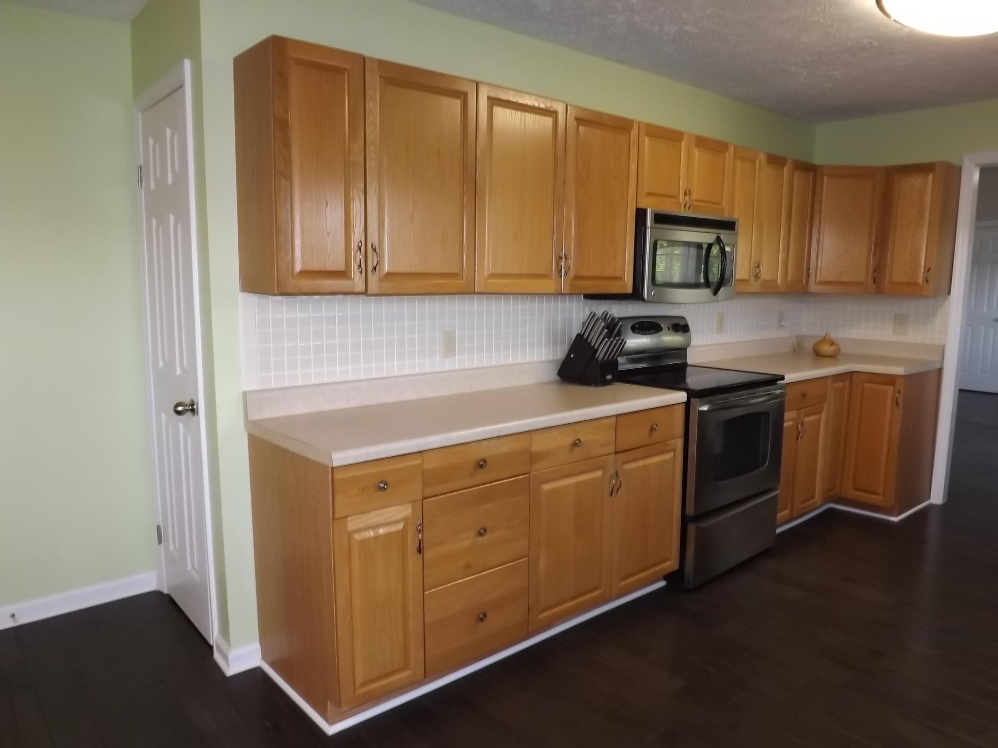 614 Ferrells Loop Road Beechgrove, TN 37018 - Photo 8 of 28 a kitchen with stainless steel appliances granite countertop a stove a sink and a microwave
