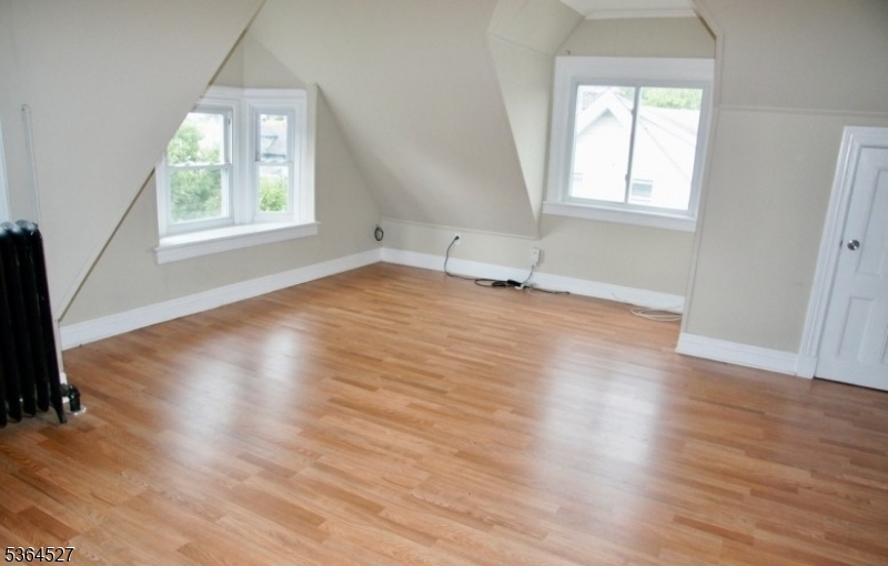 76 Grove Street Montclair, NJ 07042 - Photo 12 of 15 an empty room with wooden floor and windows