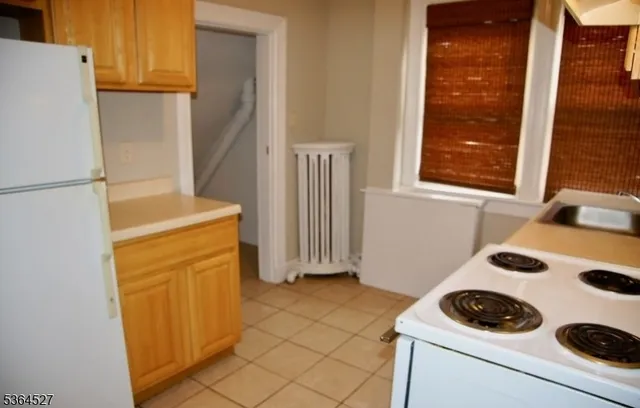 a kitchen with a refrigerator and a stove