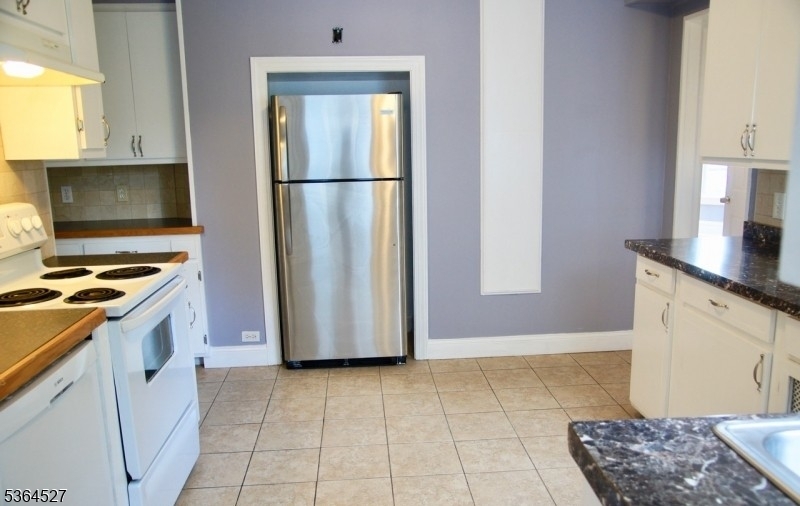 76 Grove Street Montclair, NJ 07042 - Photo 5 of 15 a kitchen with a refrigerator and a stove top oven